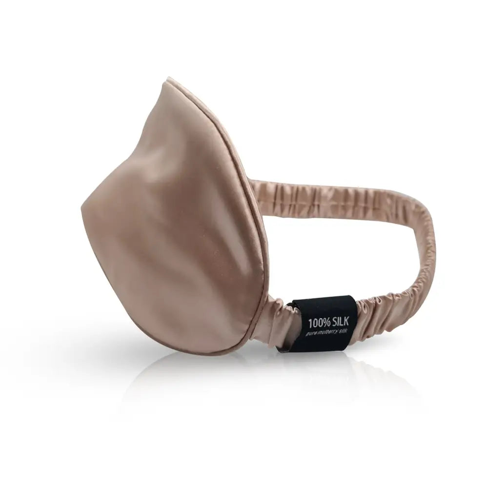 Champagnerfarbene Seiden-Schlafmaske vor beige Schlaf-Seidenmaske