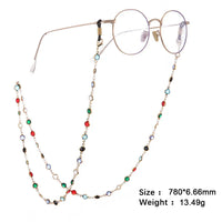 Runde Brillengestelle mit buntem, goldenem Juwelen-Perlenhalsband