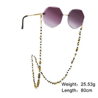 Rimless Sonnenbrille mit goldener Beaded Brillenkette, stylish und elegant
