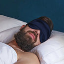 Schlafender Mann mit dunkelblauer Schlaf-Seidenmaske auf den Augen schlafen